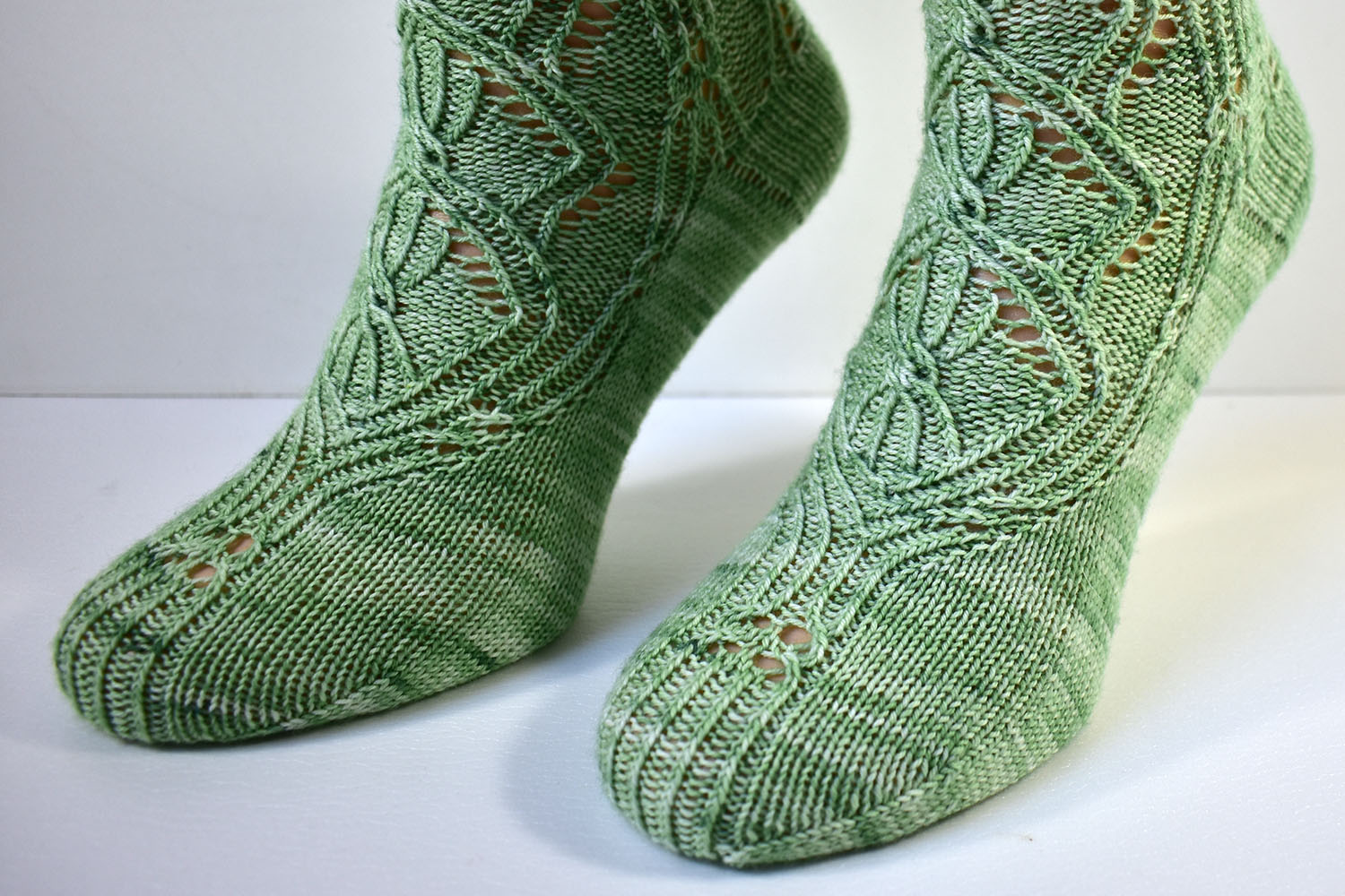 Foot detail of Triforium sock pattern with cables and lace