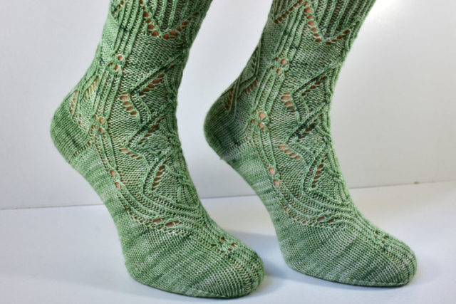 Side detail of Triforium sock pattern with cables and lace