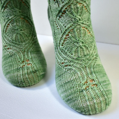 Toe detail of the triforium sock pattern with cables and lace